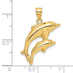 14k Yellow Gold Dolphin Pair Pendant, shown with a ruler for scale