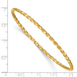 14k Yellow Gold Polished Twisted 2.50mm Slip-on Round Bangle Bracelet, shown with a ruler for scale