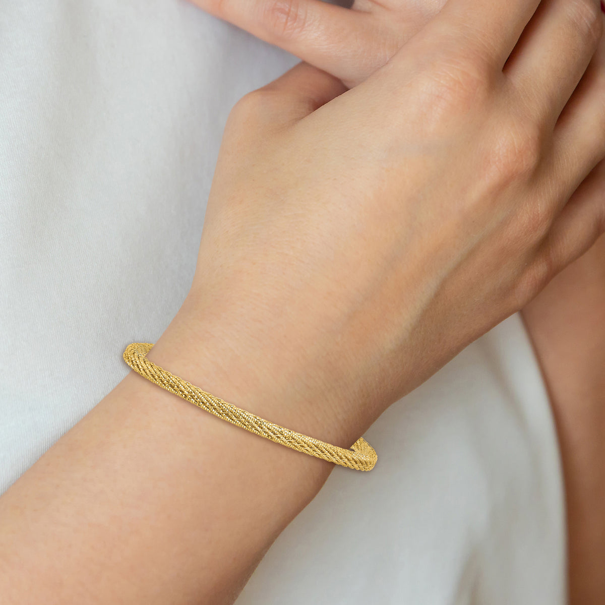 14k Yellow Gold Polished and Diamond-cut Round Woven Wire 7.5 inch Bracelet, shown on a model