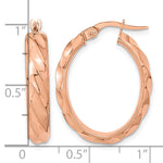 14k Rose Gold Polished Twisted Oval Hoop Earrings, shown with a ruler for scale