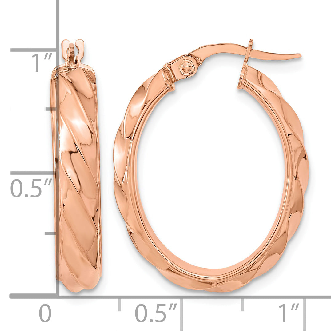 14k Rose Gold Polished Twisted Oval Hoop Earrings, shown with a ruler for scale